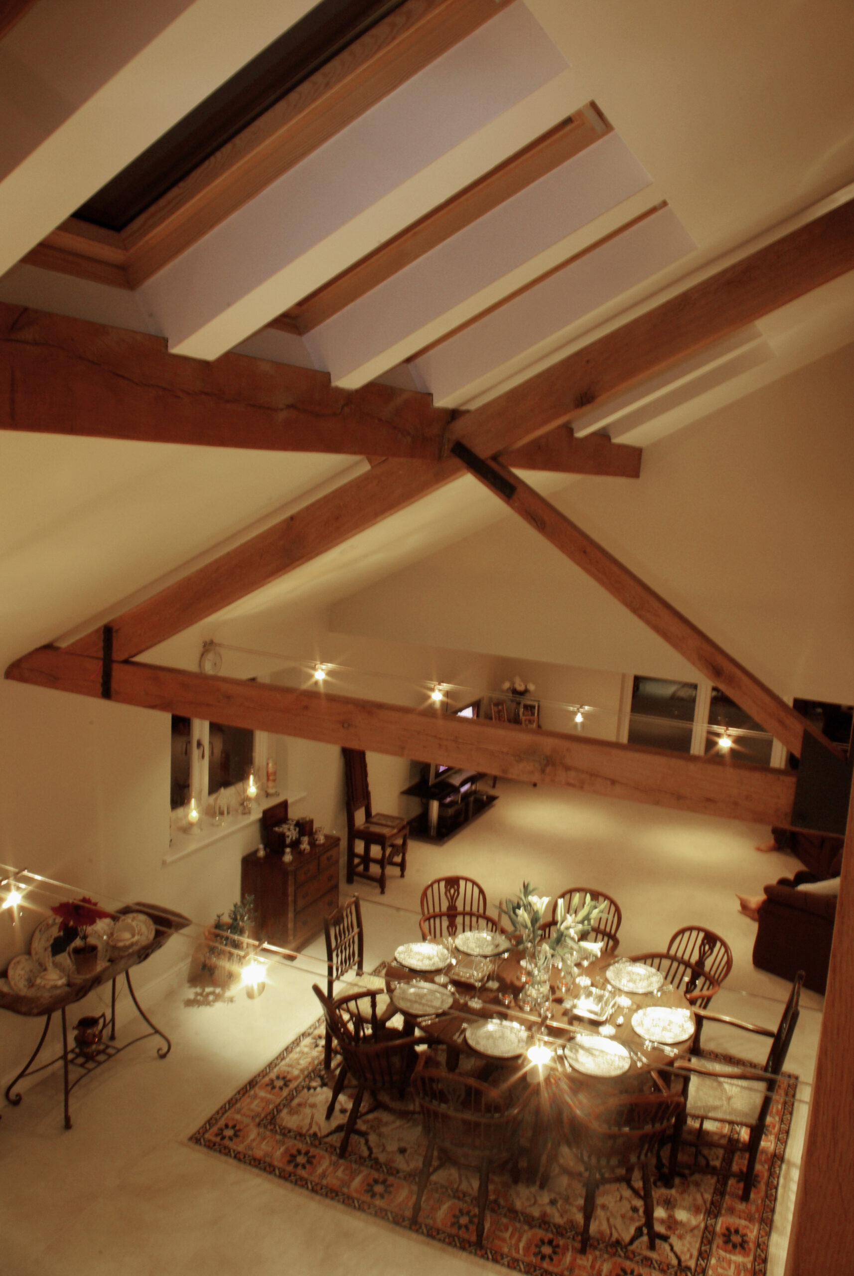 Large raked ceiling over open plan living space with new exposed timber roof trusses and rooflights over