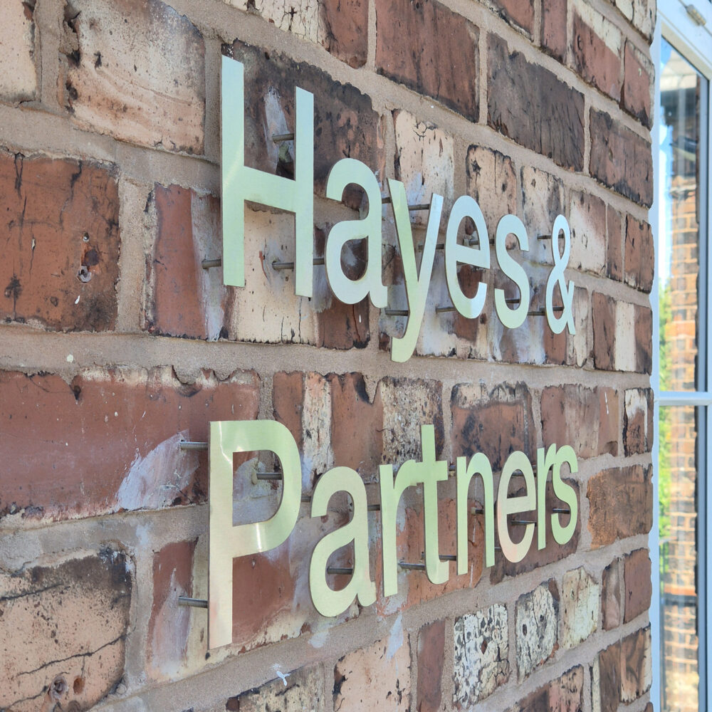 metal signage set on brick wall