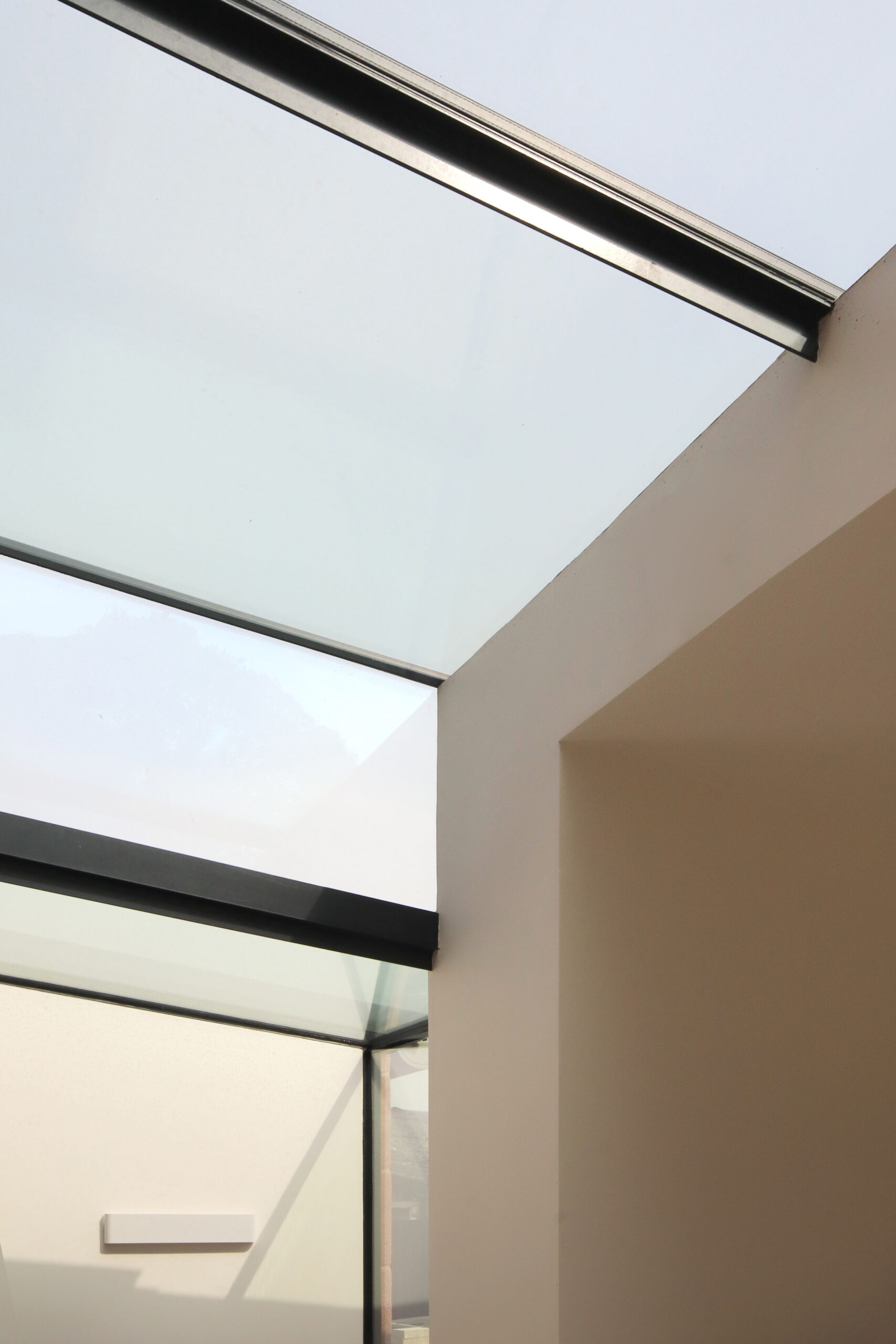 A new rear extension to a Grade 2 listed farmhouse with roof glazing bridging the new modern extension to the original stone fabric of the farmhouse