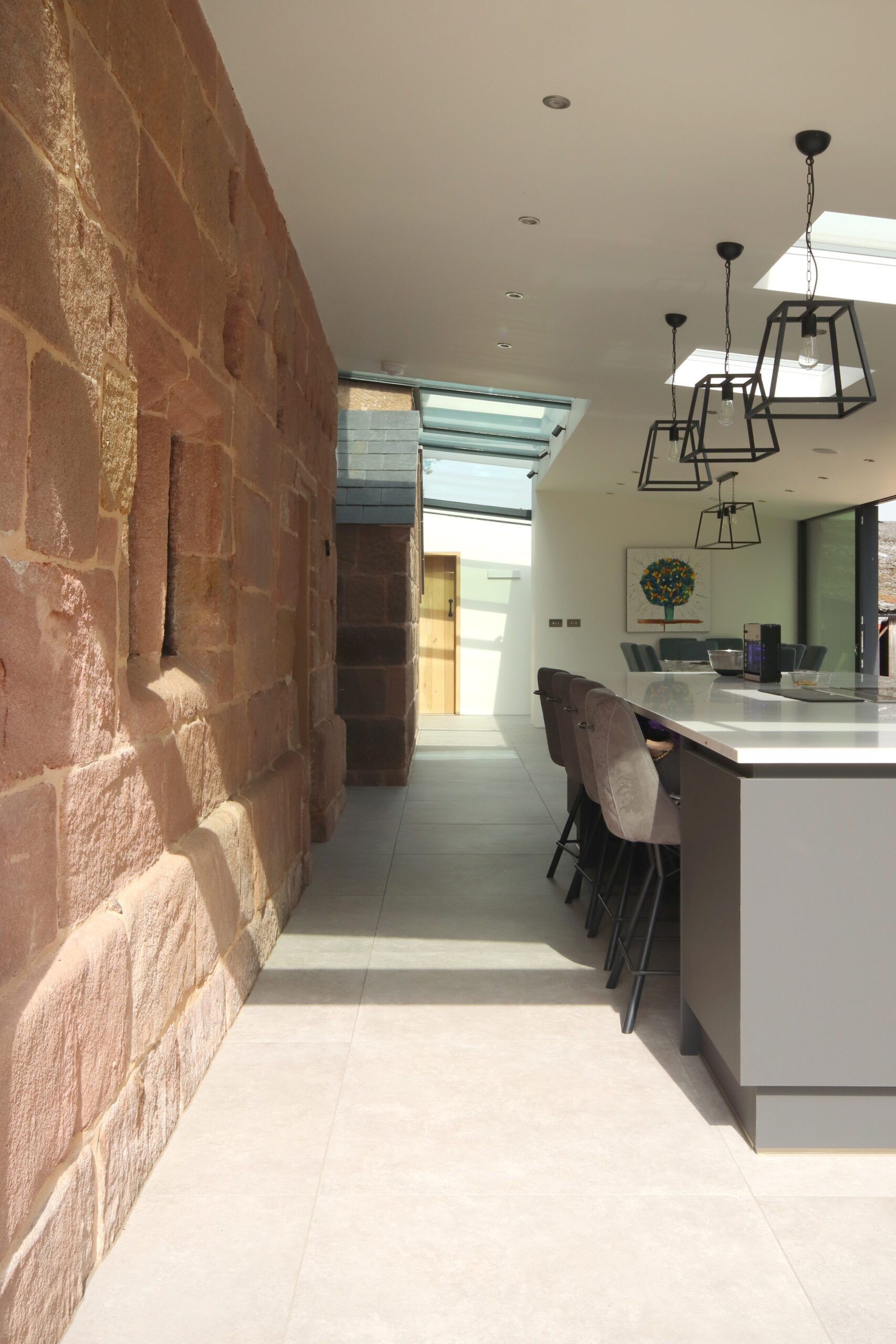 modern rear extension including kitchen and dining area to a Grade 2 listed stone farmhouse with the original external stonework exposed