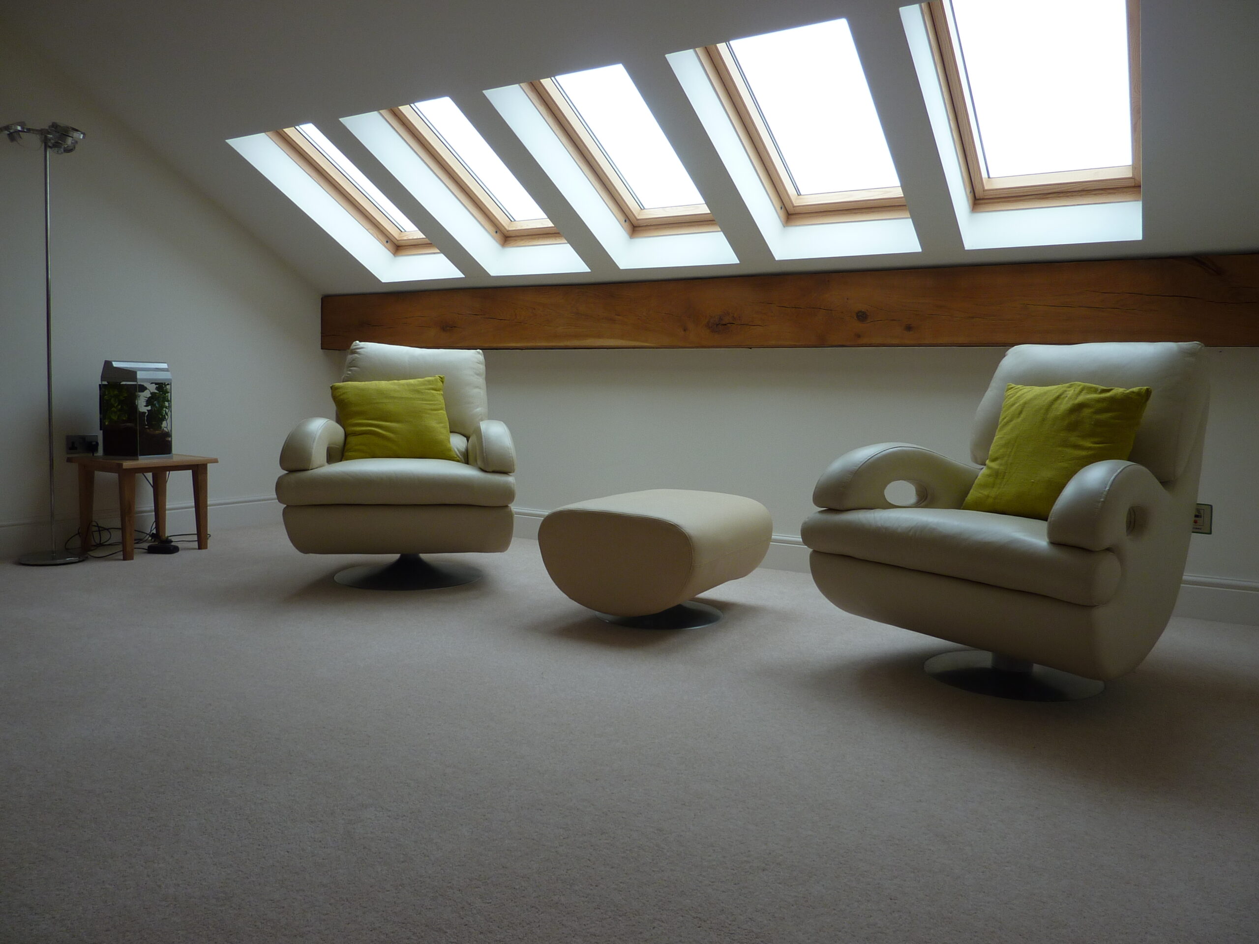 Mezzanine floor with seating and rooflights at Poole Farm with exposed roof purlins