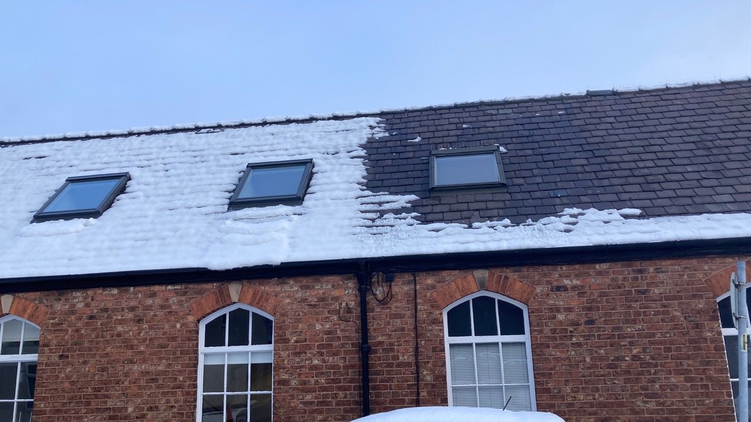 Image of the office roof at Hayes and partners after the thermal upgrade of the roof with snow in the winter
