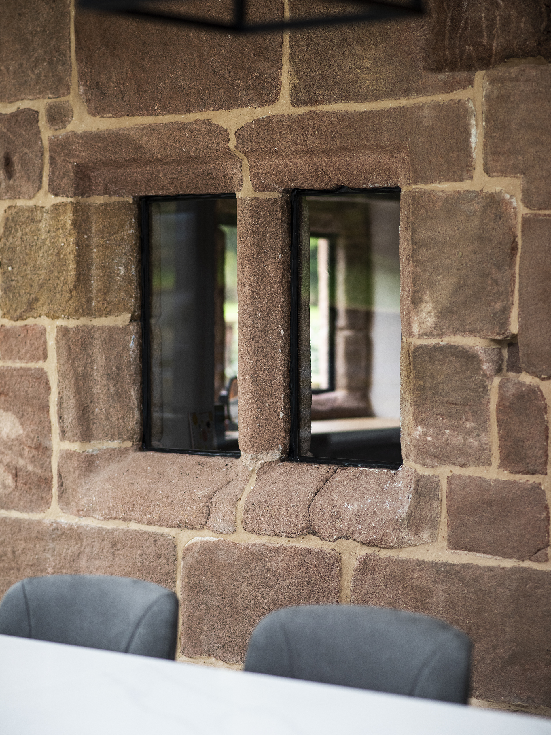 Original stone mullion window with upgraded doubele glazing at a Grade 2 listed farmhouse within a new single storey modern extension.